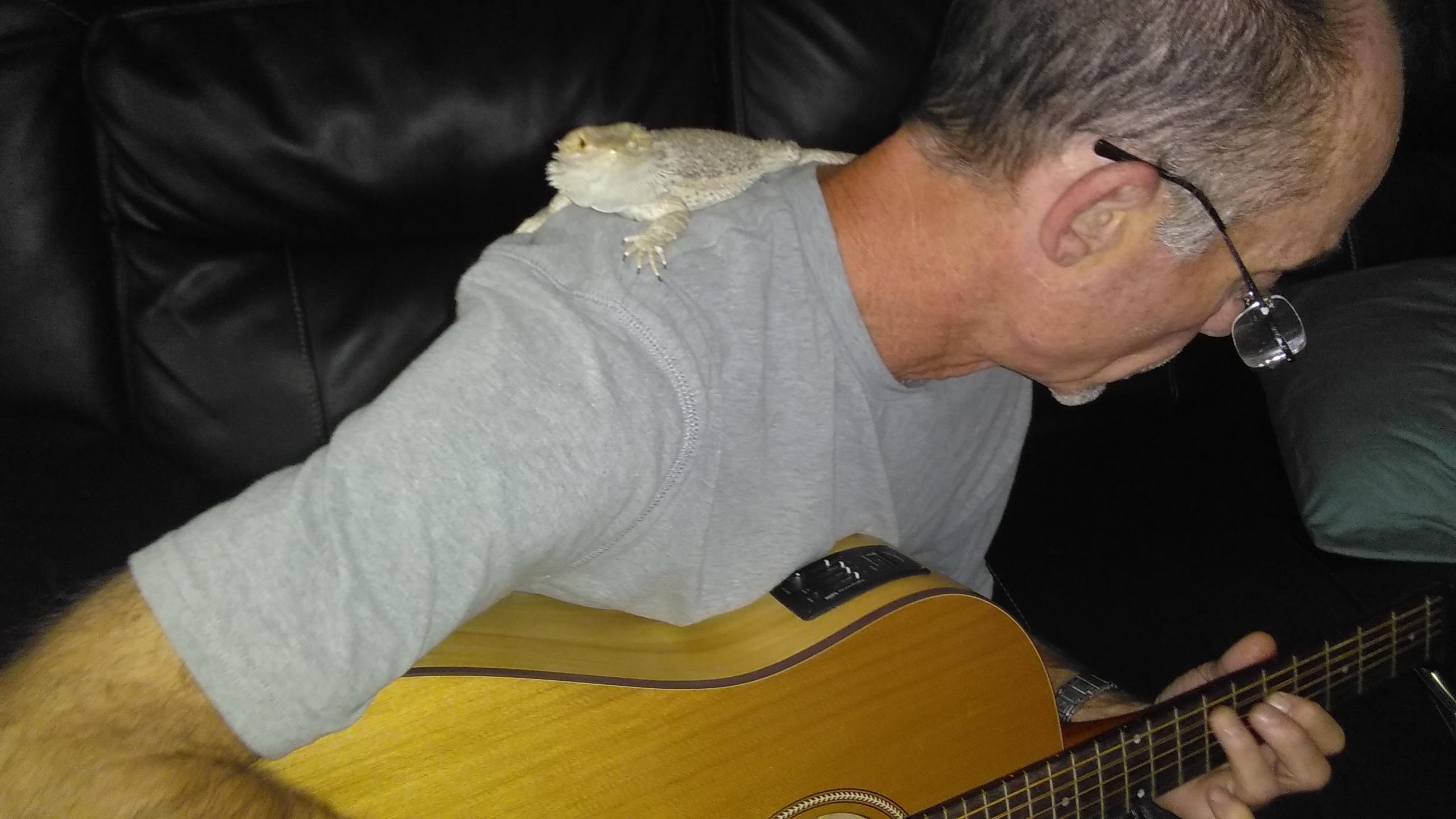 Bella listing to her dad play guitar